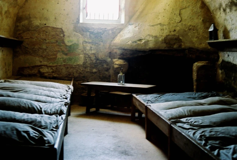 two beds in a small room that looks like a cave