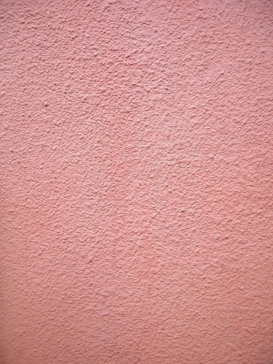 a very large window on a pink wall