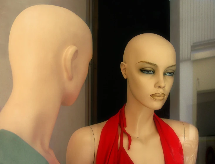 an image of a mannequin in a red scarf and wig