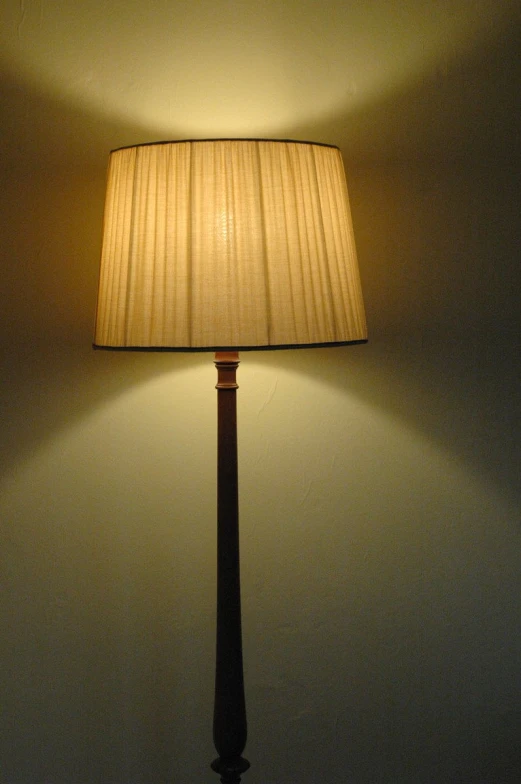 a lamp that is sitting next to a wall