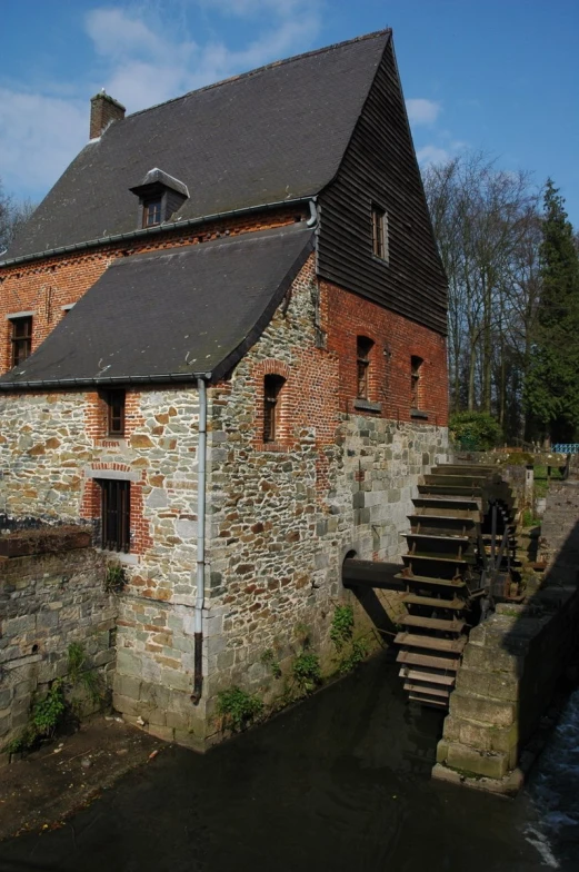 a brick house sitting on top of a river