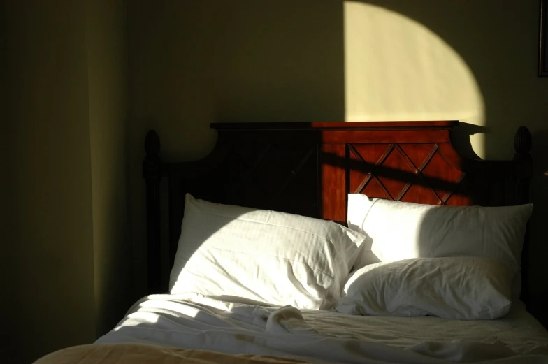 a close up of a bed with a light shining on it