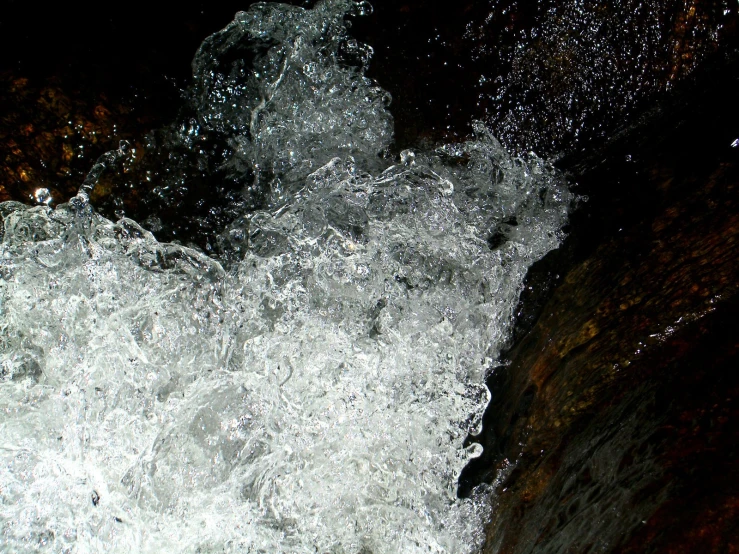 a water stream coming over a stone wall