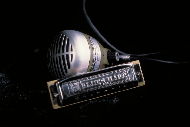 a metal speaker sitting on top of an electric guitar