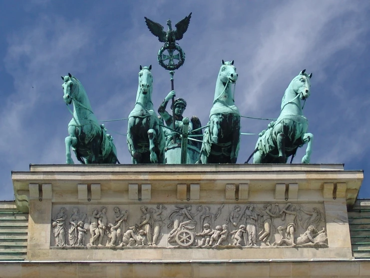 a group of four statues on horses outside