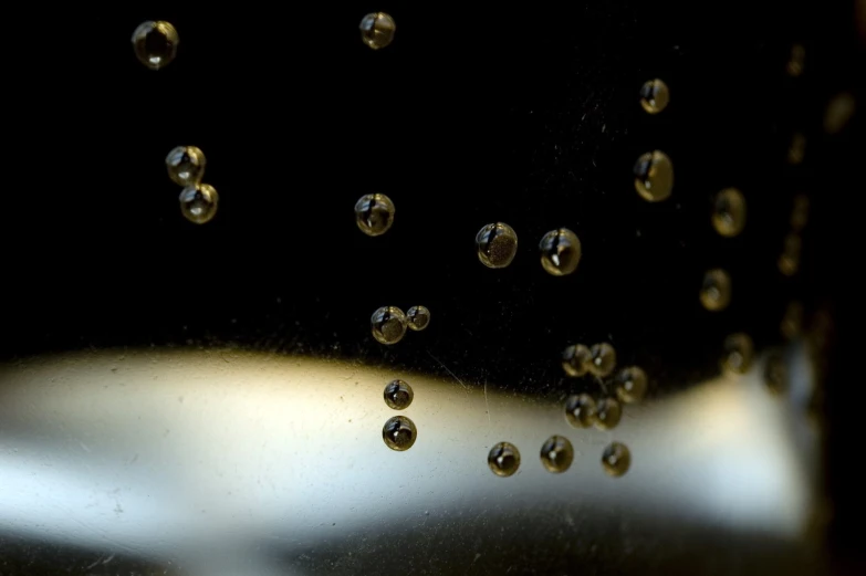 water droplets from a glass pitcher with black background