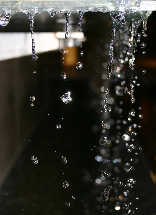 a close up view of water dripping from a window