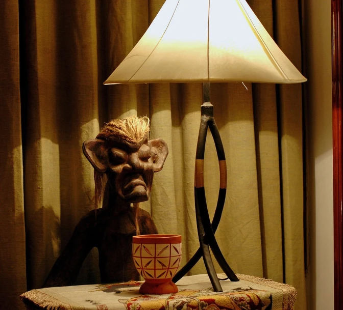 a table lamp is next to a fake creature