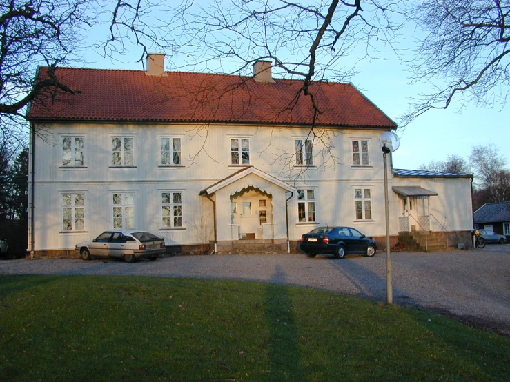 an old mansion sits in the middle of the park