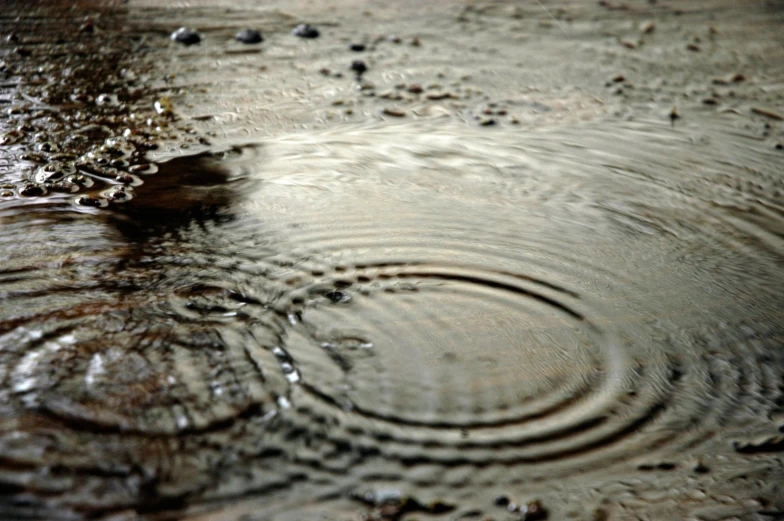 a water fountain and rain drops on the surface