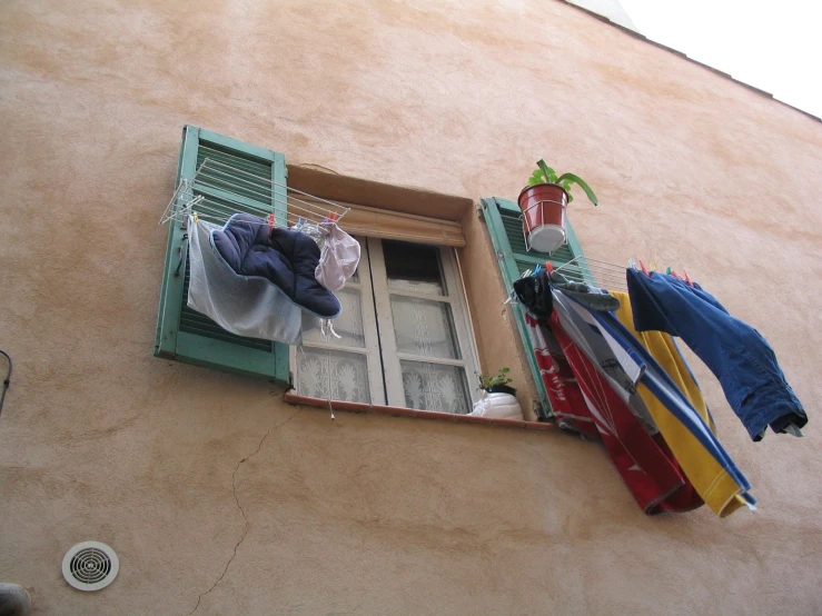 some clothes hanging next to a window