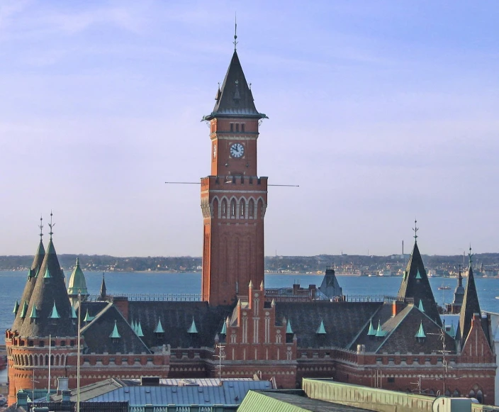 an aerial view of a big clock tower with buildings in the background