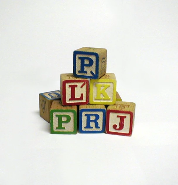 a stack of blocks with letters that spell the word p, j, r, and l