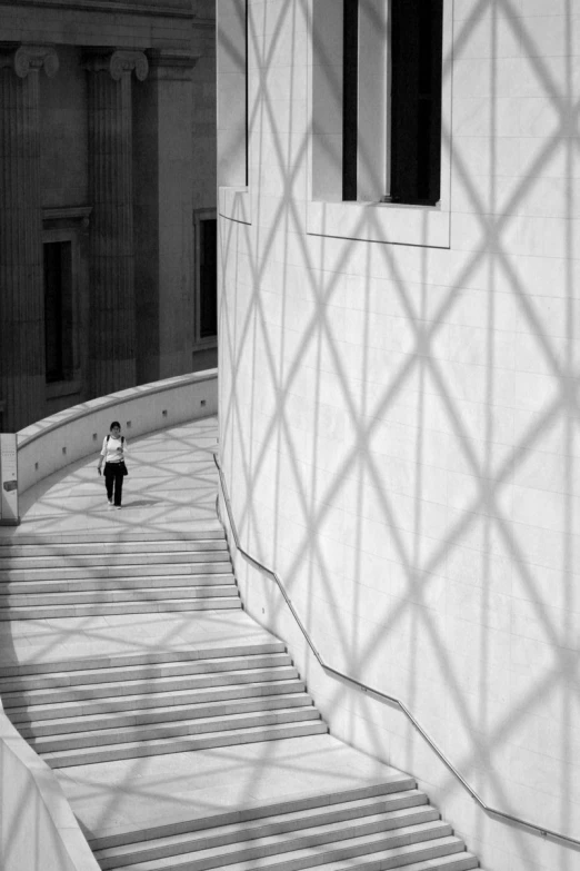 black and white po of girl with black umbrella in city