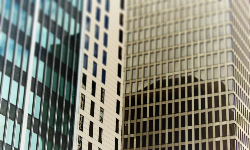 a city view looking up from a large building with many windows