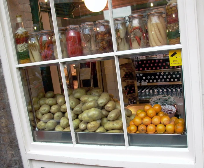the jars on the window are full of fruits and vegetables
