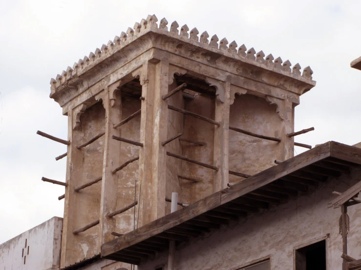 a tall white tower with an ornamental top