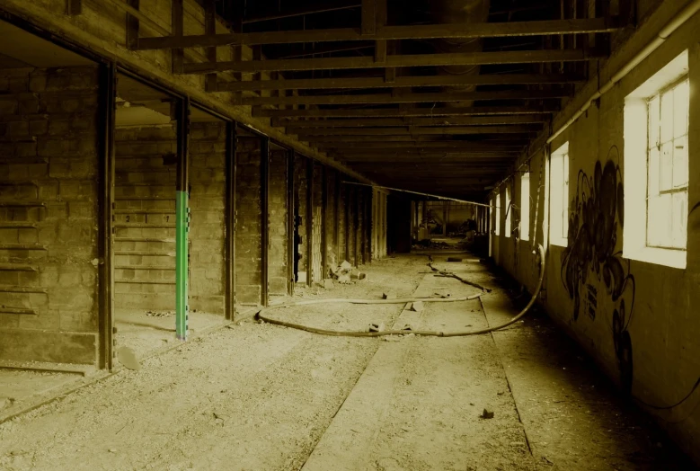 a dirty room with graffiti and wood beams