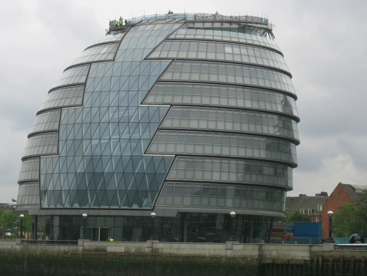 a curved building on the water by itself