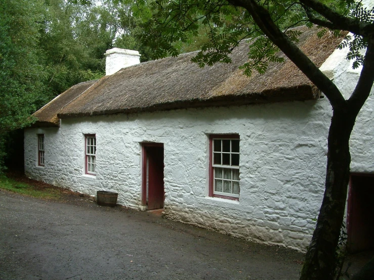 white stone cottages in a rural area with red doors and window frames