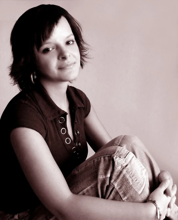 a woman sitting on the floor with her legs crossed