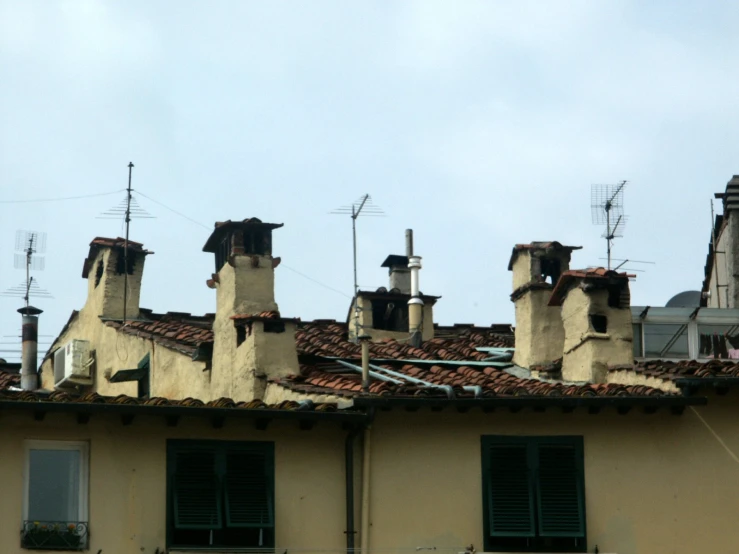 an old building with three chimneys on the top