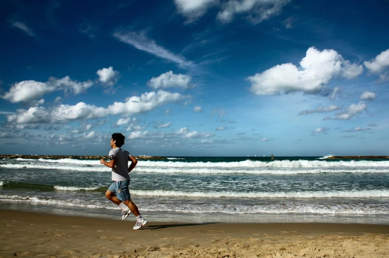 a man that is running on a beach