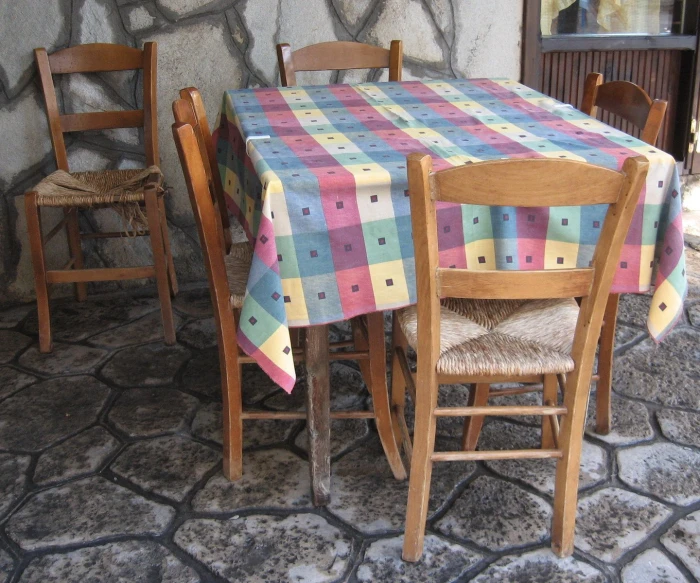 a dining table with two wooden chairs in front of it