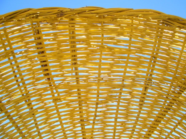 a yellow basket sitting under a blue sky