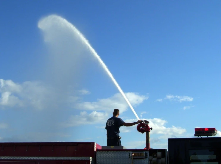 a man who is in the back of a truck is doing a pipe work