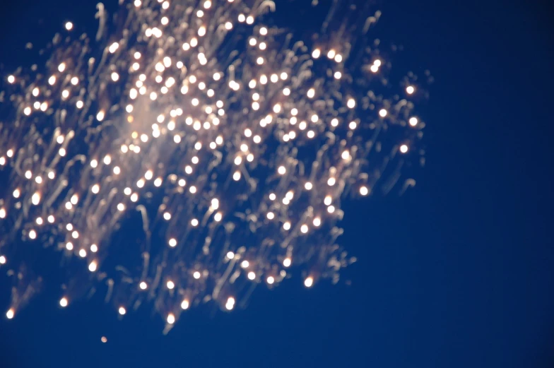 a large firework is in the dark blue sky