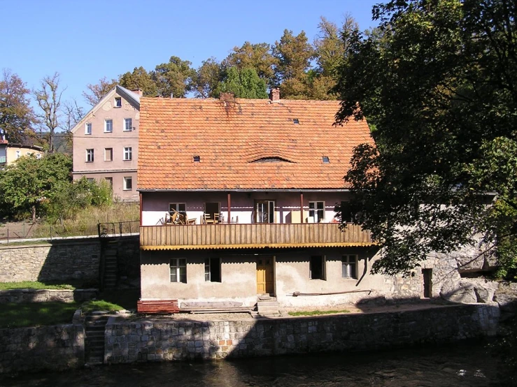 the house is built on a hill next to water