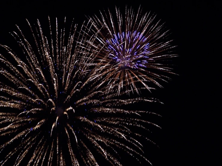 a brightly colored fireworks is lit up in the dark sky