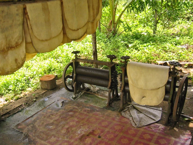 old machine used to spin needles sitting in shade on a picnic table