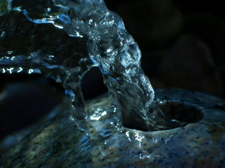 water is pouring from the back of a rock