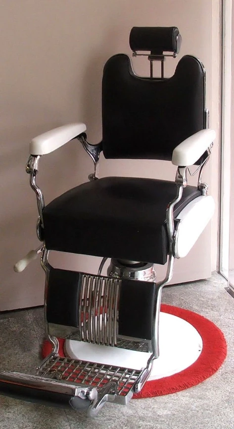 an image of a barber chair with chrome wheels