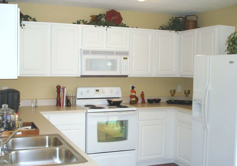 a kitchen with white cabinets and a stove