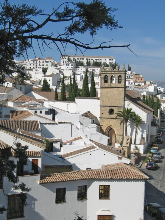 the building with towers have red and white roof tiles