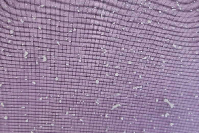 water drops falling off of a window on purple tiled surface