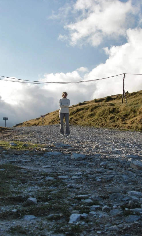 a man that is standing on top of a gravel ground