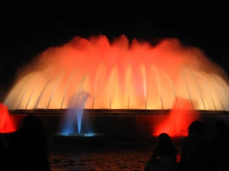 a large colorful fountain lit up at night