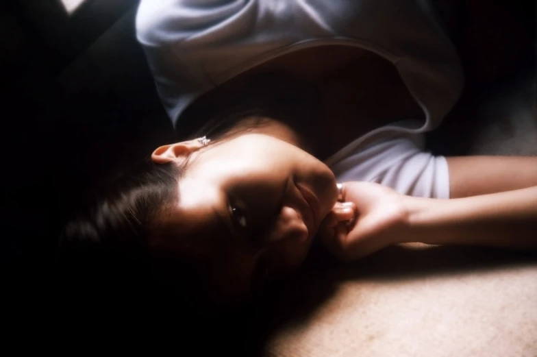 a woman laying down on a table holding onto the table