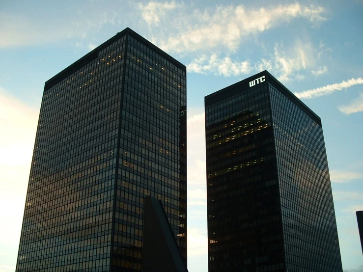 two very large office buildings towering over other one