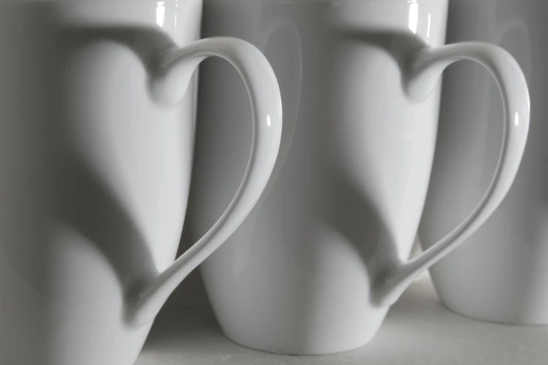 several white coffee cups in front of the wall