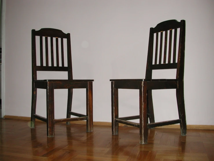 two chairs on the floor in an empty room