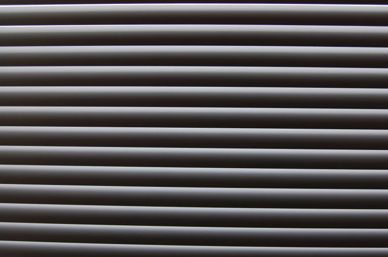 shadows on a wall made out of gray and white wavy lines