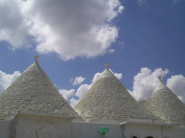 several white roof tops that are near a fence