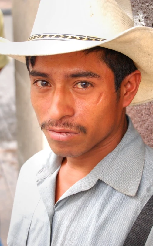 a man wearing a cowboy hat on top of his head