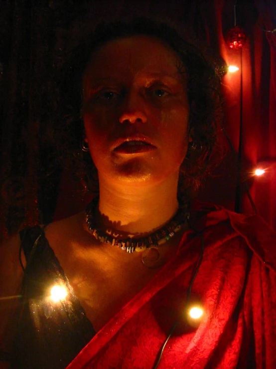 woman wearing red outfit standing in front of a christmas tree