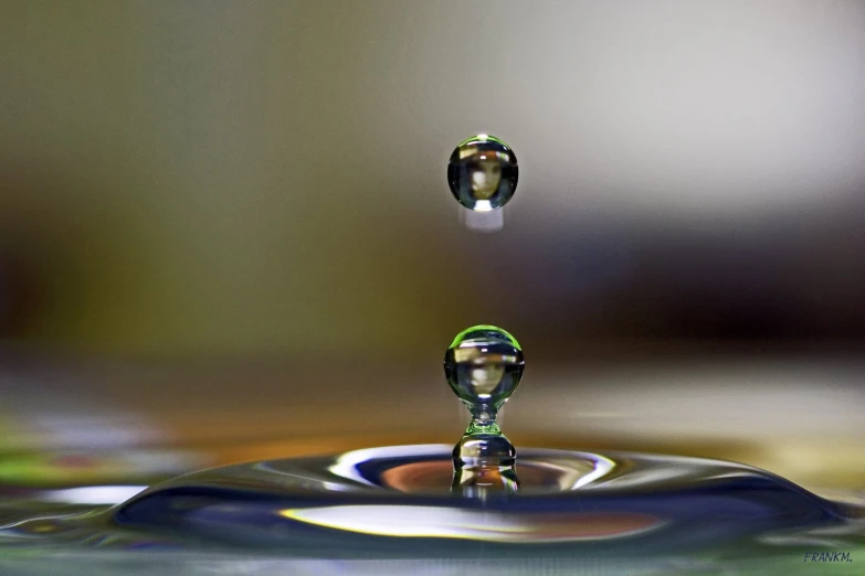 an extremely detailed water droplet that has some clear liquid